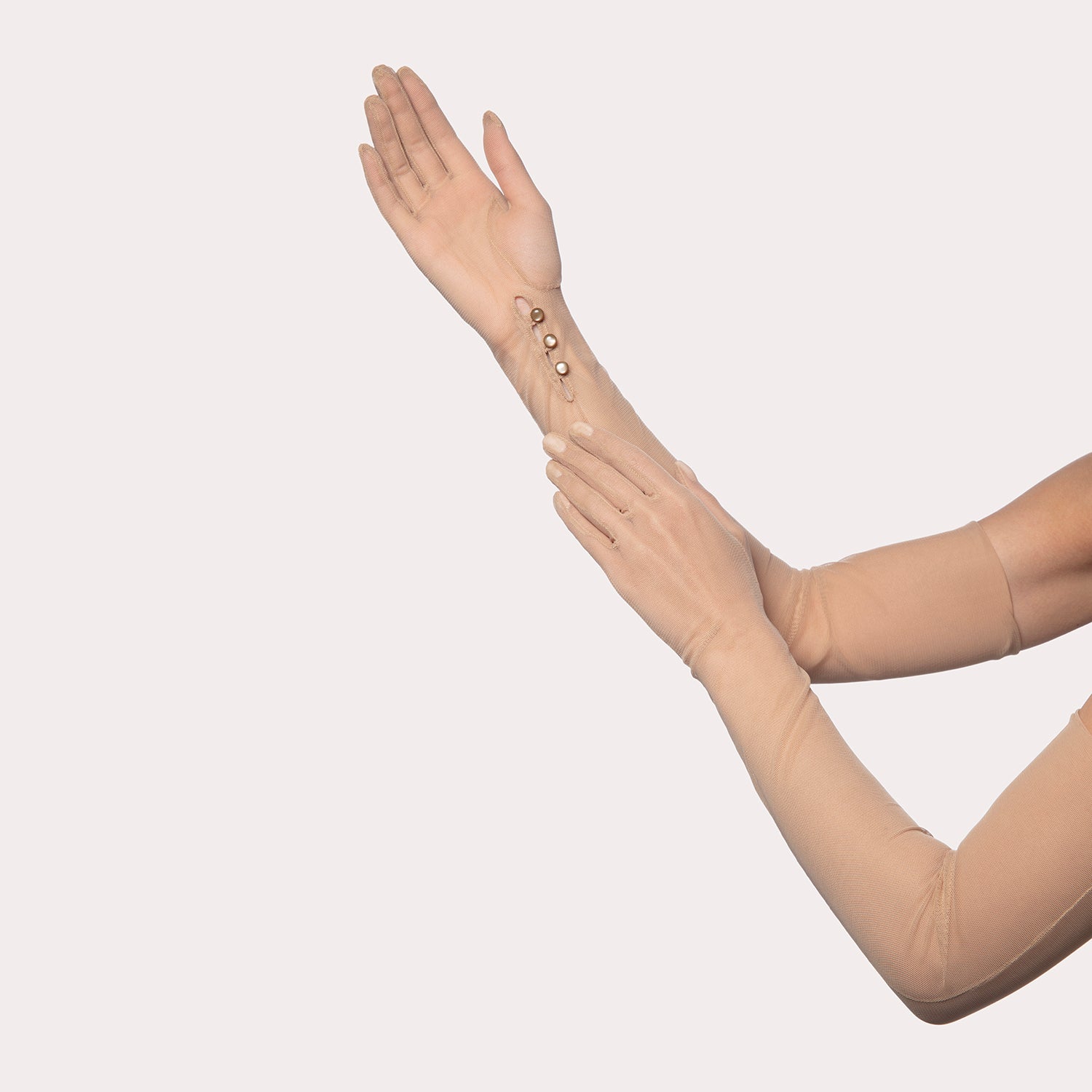 A pair of long sheer mesh opera gloves in nude beige, featuring delicate button details on the inner wrist, displayed on a light background.