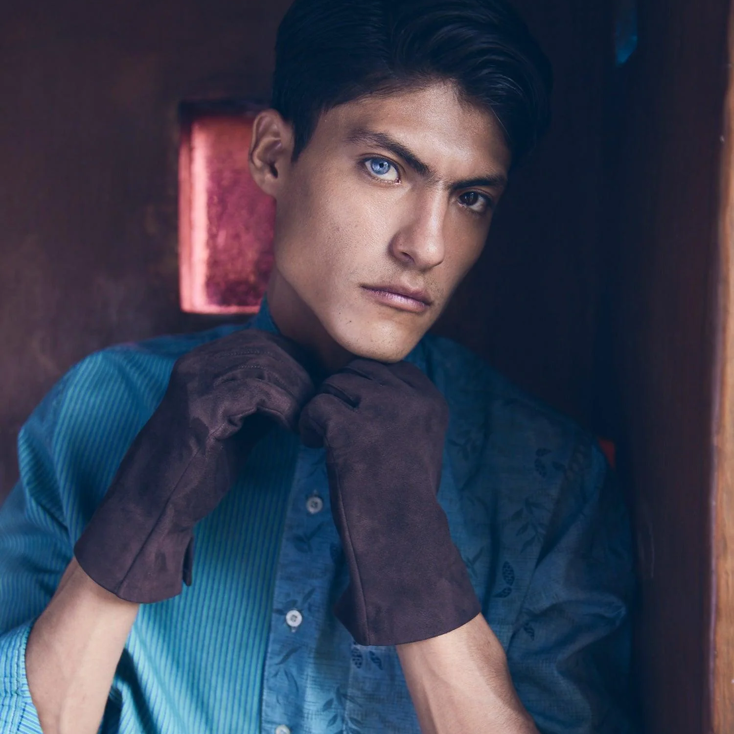 Brown suede gloves with teal blue dress shirt, menswear portrait